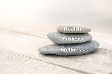 Health, fitness and wellness words written on stones. Healthy living concept