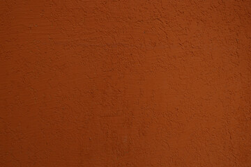 modern brown wall background. new dark red concrete wall texture, front view. Copper backdrop. paint on a concrete wall painted in brown and orange tone.