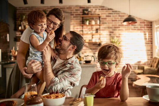 Family having fun while eating breakfast together