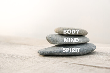 Body, mind and spirit words written on zen stones. Copy space and zen concept