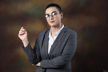Confident young widow woman in corporate suit wearing eyeglasses. Portrait of smiling bald business woman isolated against grey background with copy space. Proud university student girl with specs 