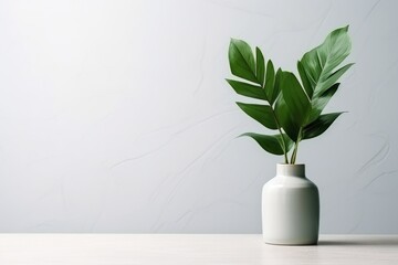 Lush Green Plant Leaves in a Sleek Ceramic Vase