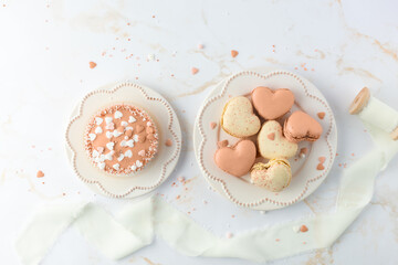 French sweet cookies macarons macaroon and cupcake on retro plates on marble table background....
