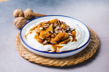 Labneh yogurt cream cheese with roasted apples, copy space. Traditional arabian or middle eastern homemade labneh dip. Greek yogurt.