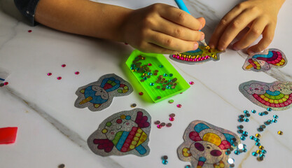 diamond mosaic set with crystals intermediate gluing process by child