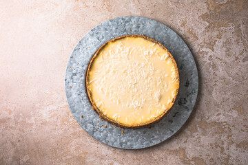 Raw vegan lime coconut cheesecake on marble table, background