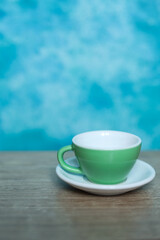 Coffee cup on wooden table and blue wall background, stock photo