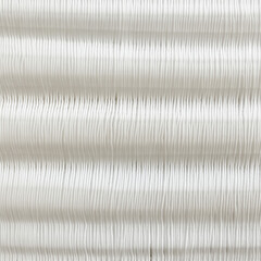 Macro shot of white knitted fabric with detailed stitch pattern and texture
