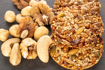 Several Thaler cookies with nuts on slate stone, macro.