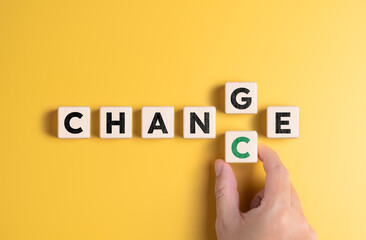 Hand holds wooden cube with word CHANGE to CHANCE. Personal development and career growth or change...