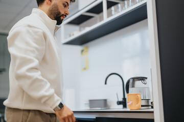 Businessman taking a rest. He just prepared himself a tea.