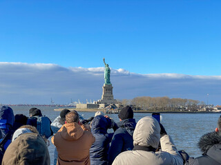 New York, New York – January 11, 2024: the view of the Statue of Liberty from the ferry boat with tourists