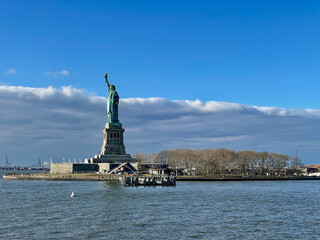 Fototapeta na wymiar New York, New York – January 11, 2024: the view of the Statue of Liberty from the ferry boat with tourists
