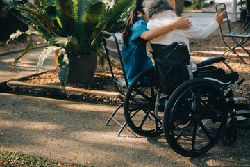 A nurse take care a senior male on wheelchair in his garden at home