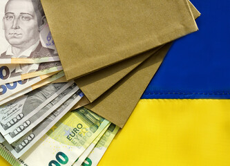 Currency in convet on the Ukrainian flag. Dollars, euros and hryvnias.