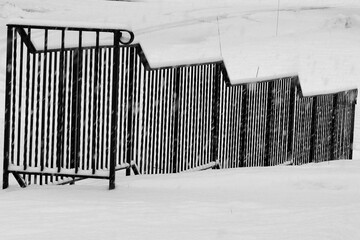 Obraz premium The black metal railing is wise to hold onto with ice and snow on the ground.