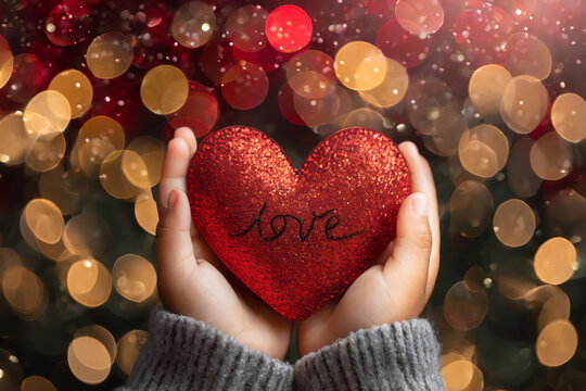 Hispanic Childs Hands Holding A Heart In Front Of A Bokeh Background