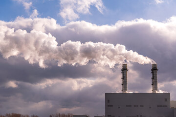 energy economy: vapour from twin smoke stacks of  gas fired electricity power plant blows from...