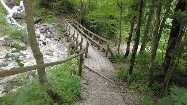 wooden bridge in forest near Slapišče Palenk waterfall