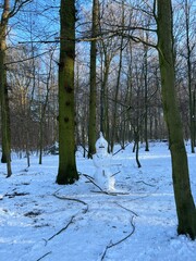 forest in winter with snowman