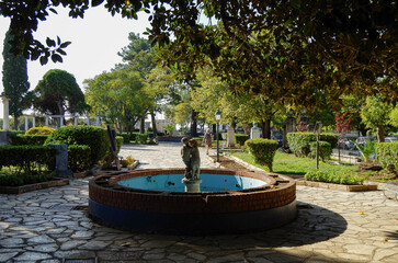 Romantic backstreet, side street or alleys in historic old town of Corfu Island, Greece with Mediterranean style architecture facades, a landmark sightseeing tourist spot in downtown Aegean Sea