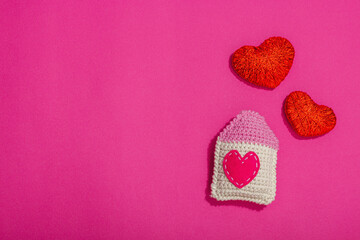 Handmade Valentines Day concept. Creative house figurines, traditional hearts, spring crocheting