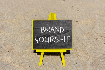 Brand yourself symbol. Concept words Brand yourself on beautiful black blackboard. Beautiful sand beach background. Business brand yourself concept. Copy space.