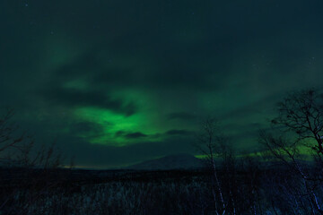 Naklejka na ściany i meble Image of the Northern Lights in Abisko, Sweden