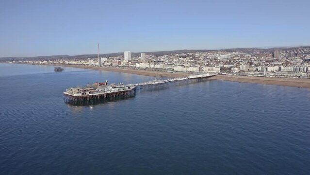 Aerial video of the Victorian Palace Pier in Brighton, a popular attraction at this popular resort City in East Sussex, England.