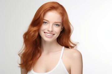 Fototapeta premium Beautiful red haired Model: Closeup Portrait, Radiant Smile, Clean Teeth - Ideal for Dental Ads. Isolated on White Background