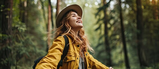 Sustainable eco friendly fashion clothes woman feeling free with open arms in woods forest happy breating clean air Travel tourist girl walking in natural healthy environment renewable resource - obrazy, fototapety, plakaty