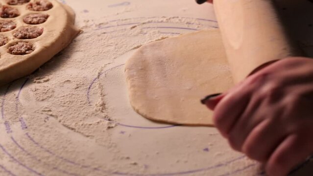 Girl rolling out dough on the table