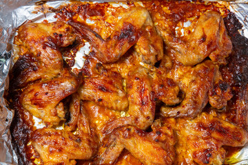 Chicken wings baked in soy sauce and garlic marinade with a crispy crust close-up