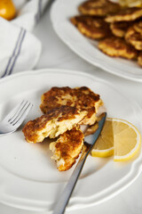  Golden Brown Chopped Chicken Cutlets or Patties with mozzarella cheese on white plate.. Minimalistic food photo on white marble background 