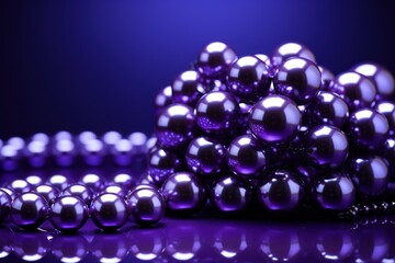 a bunch of shiny balls sitting next to each other on a purple surface with a reflection of them on the surface.