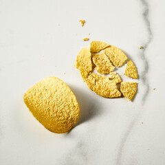 Pair of potato chips: whole and broken on white marble background. Minimalistic food photo. 
