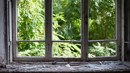 open window with old wooden frame. old window. finely broken glass. old house, retro. cracked window frame. cracked old paint, pieces of glass. space for text. large pieces of glass. horror