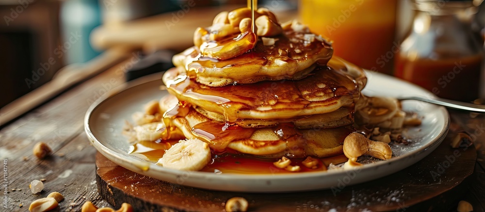 Poster banana cashew pancakes with bananas and salted caramel sauce the toning selective focus. Copy space image. Place for adding text or design