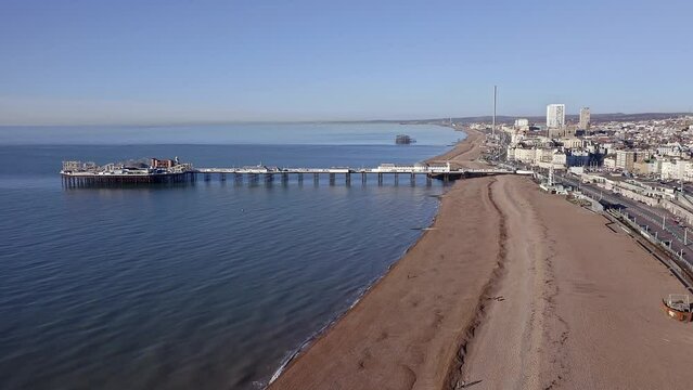 Aerial footage approaching the Victorian Palace Pier in Brighton along the beach and Madeira drive.