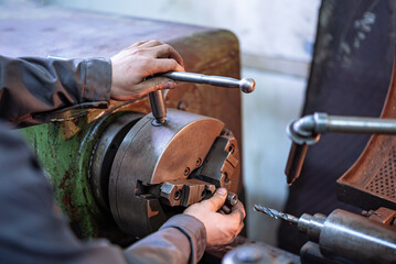 Person Working on Metal, Creating, Shaping, and Crafting. An individual focused and skilled in the...