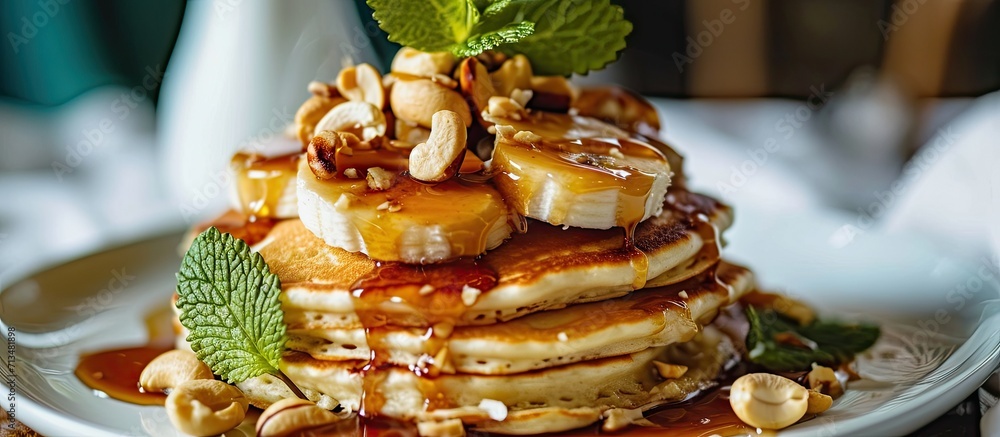 Poster banana cashew pancakes with bananas and salted caramel sauce the toning selective focus. Copy space image. Place for adding text or design