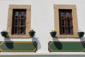 Barred wood windows on white wall, Ottoman building in the Old Bazaar, Central Square area -Pazari i Vjeter, Sheshi Iliria-. Korca-Albania-254