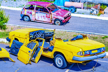 On the car crash traffic accident scene a yellow car with its roof torn off after a collision. Road incident...