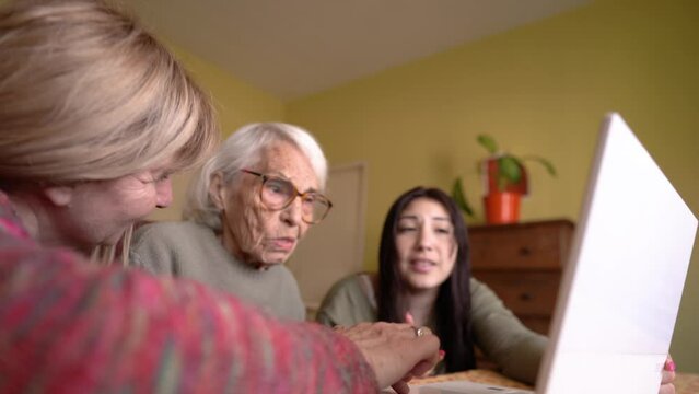 Connected Generations: Elder female Enriching Her Skills on the Computer. Copy space.