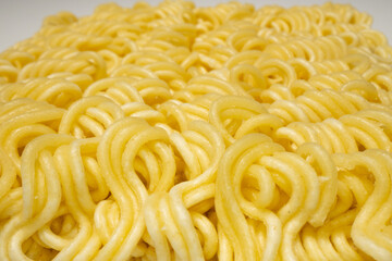 Instant noodles on a white plate, close-up, macro.
