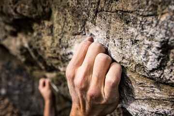 hand of a rock climber on the wall