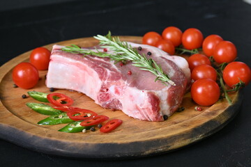 Overhead fresh meat. Pork chops with rosemary and spices on a wooden board