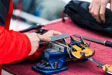 woman filing crampons