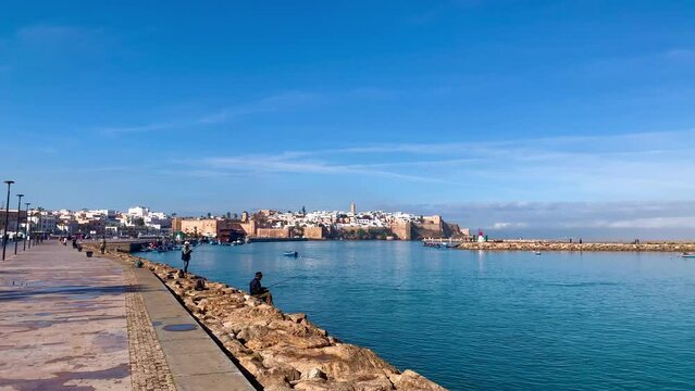 RABAT, MOROCCO - January 07-2024 : Fisher men's in River Bouregreg Rabat , Morocco View of the harbour of Rabat, Morocco located in the river Bou Regreg at the mouth of the Atlantic Ocean.