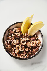 Sauteed Calamari. Baby Calamari cooked with oregano, thyme and garlic (Italian Style). Served with lemon and red pepper flakes. Spicy